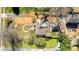 Aerial view of house with a landscaped yard, driveway, and mature trees at 1815 W Sugar Creek Rd, Charlotte, NC 28262