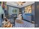 A delightful Bedroom with a cozy crib and matching blue furniture at 1815 W Sugar Creek Rd, Charlotte, NC 28262