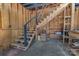 Staircase to second level of converted garage with unfinished wood and black railing at 1815 W Sugar Creek Rd, Charlotte, NC 28262