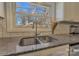 Close-up of kitchen sink and granite countertops. Features stainless steel sink and faucet fixture at 1815 W Sugar Creek Rd, Charlotte, NC 28262