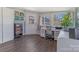 Bright sunroom with multiple windows, a desk, and built in storage shelves at 1815 W Sugar Creek Rd, Charlotte, NC 28262