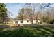 Large grassy backyard with a fire pit and a view of the home's exterior at 1909 Stokes Ferry Rd, Salisbury, NC 28146