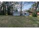 View of two storage sheds in the backyard of the property; surrounded by mature trees at 1909 Stokes Ferry Rd, Salisbury, NC 28146