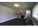 Cozy living room featuring a decorative fireplace, built-in shelves, and hardwood floors at 1909 Stokes Ferry Rd, Salisbury, NC 28146