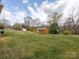 Large backyard with two sheds on a partly cloudy day with blue sky at 207 Sigmon Rd, Statesville, NC 28677