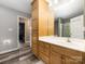 Well-lit bathroom with wooden cabinets, ample counter space, and a mirror, combines functionality with style at 207 Sigmon Rd, Statesville, NC 28677