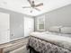 Bedroom with a ceiling fan and a double-door closet; natural light filters through a window at 207 Sigmon Rd, Statesville, NC 28677