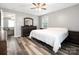 This spacious bedroom features neutral walls, coordinating dresser, and an adjacent room that enhance comfort and style at 207 Sigmon Rd, Statesville, NC 28677