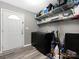 Laundry room with modern washer, dryer and storage shelves, with a door to the outside at 207 Sigmon Rd, Statesville, NC 28677