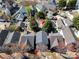 Aerial view of gray home in a suburban neighborhood, showcasing the roof and surrounding trees at 232 Faust Rd, Davidson, NC 28036