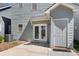 Backyard of two story home with concrete patio, a small garden and a utility door at 232 Faust Rd, Davidson, NC 28036