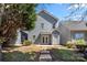 View of the backyard of a two-story home with blue siding, a small patio and some landscaping at 232 Faust Rd, Davidson, NC 28036