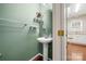 Charming powder room with a pedestal sink and unique green paint at 232 Faust Rd, Davidson, NC 28036