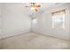 Cozy bedroom featuring neutral carpet, two windows, and bright white walls at 232 Faust Rd, Davidson, NC 28036