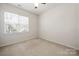 Bedroom featuring a ceiling fan, carpet and a large window with lots of natural light at 232 Faust Rd, Davidson, NC 28036