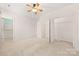 Spacious bedroom featuring neutral carpet, a ceiling fan, and bright white walls at 232 Faust Rd, Davidson, NC 28036