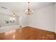 Open dining room with hardwood floors and a view into an additional living space at 232 Faust Rd, Davidson, NC 28036