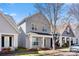 View of the exterior of a charming gray two-story home, landscaped yard and covered porch at 232 Faust Rd, Davidson, NC 28036