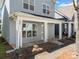 Close-up of the front porch of a gray home with stone accents and white columns at 232 Faust Rd, Davidson, NC 28036