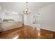 Kitchen area featuring a tiled breakfast bar, modern appliances, and hardwood floors at 232 Faust Rd, Davidson, NC 28036