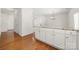 Bright kitchen island with granite counters and hardwood floors leading into the living room at 232 Faust Rd, Davidson, NC 28036