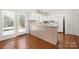 Bright kitchen with tile breakfast bar and hardwood floors at 232 Faust Rd, Davidson, NC 28036