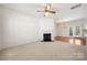 Spacious living room featuring a fireplace, ceiling fan and french doors leading to a deck at 232 Faust Rd, Davidson, NC 28036