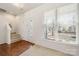 Bright living room featuring hardwood floors, a staircase, a front door and a large window at 232 Faust Rd, Davidson, NC 28036