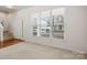 Bright living room featuring hardwood floors, a staircase, a front door and a large window at 232 Faust Rd, Davidson, NC 28036