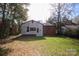 View of the backyard and back of home with green grass and trees at 2825 Bancroft St # C, Charlotte, NC 28206