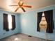 Bedroom featuring a ceiling fan, two windows with curtains and an air conditioning unit at 2825 Bancroft St # C, Charlotte, NC 28206