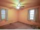 Bedroom with peach colored walls, carpeted floors, and natural light from two windows at 2825 Bancroft St # C, Charlotte, NC 28206