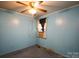 Bedroom featuring blue walls, carpeted floors, ceiling fan and window AC unit at 2825 Bancroft St # C, Charlotte, NC 28206