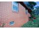 Angle view of the exterior of the home showcasing the brick foundation and window at 2825 Bancroft St # C, Charlotte, NC 28206