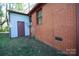 Exterior side view of a brick and siding house with a shed at 2825 Bancroft St # C, Charlotte, NC 28206