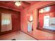 Hallway featuring peach colored walls and wood paneling looking into the retro kitchen at 2825 Bancroft St # C, Charlotte, NC 28206