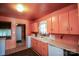 Retro kitchen with peach cabinets, white appliances, and vintage patterned floors at 2825 Bancroft St # C, Charlotte, NC 28206