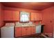 Retro kitchen features peach cabinets, white appliances, and patterned flooring at 2825 Bancroft St # C, Charlotte, NC 28206