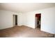 Spacious living room featuring carpeted floors and an open layout, leading to other rooms at 2825 Bancroft St # C, Charlotte, NC 28206