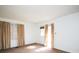 Bright living room with sunlit windows, white walls, and classic window curtains at 2825 Bancroft St # C, Charlotte, NC 28206