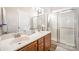 Bathroom featuring a double vanity, a glass-enclosed shower, and ample lighting at 4108 Twenty Grand Dr, Indian Trail, NC 28079