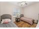 Cozy bedroom with twin beds, wood-look floors, and a window with natural light at 4108 Twenty Grand Dr, Indian Trail, NC 28079