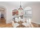 The dining area offers views to the kitchen, a decorative chandelier, and a sunlit window at 4108 Twenty Grand Dr, Indian Trail, NC 28079