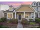 Charming home featuring stone accents, a covered porch, and manicured landscaping at dusk at 4108 Twenty Grand Dr, Indian Trail, NC 28079