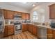 Well-lit kitchen featuring stainless steel appliances, wood cabinetry, and sleek countertops at 4108 Twenty Grand Dr, Indian Trail, NC 28079