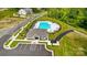 Aerial view of a community with a swimming pool, clubhouse, and manicured green spaces at 4223 Black Ct # 195, Harrisburg, NC 28075