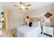 Bedroom featuring a decorative headboard, white bedding, and a ceiling fan with lighting at 4223 Black Ct # 195, Harrisburg, NC 28075