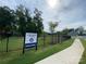 Community dog park featuring black metal fencing, green grass, and community sign at 4223 Black Ct # 195, Harrisburg, NC 28075