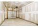 Spacious unfinished garage with a concrete floor, overhead door and lighting at 4223 Black Ct # 195, Harrisburg, NC 28075