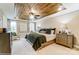 The main bedroom featuring a decorative wood tray ceiling, plush bedding and lots of natural light at 4223 Black Ct # 195, Harrisburg, NC 28075